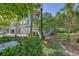 Serene street view showcasing a row of townhouses, mature trees, and verdant landscaping at 2036 Kings Gate Ln, Mount Pleasant, SC 29466