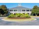 Exterior view of the main building surrounded by a roundabout with manicured greenery at 2036 Kings Gate Ln, Mount Pleasant, SC 29466