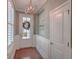 Inviting foyer with hardwood floors, decorative wainscoting, and a stylish light fixture at 2036 Kings Gate Ln, Mount Pleasant, SC 29466