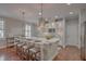 Bright kitchen featuring a marble island with seating, stainless steel appliances, and custom cabinetry at 2036 Kings Gate Ln, Mount Pleasant, SC 29466