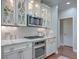 Elegant kitchen boasting marble countertops, custom cabinetry with glass fronts, and stainless steel appliances at 2036 Kings Gate Ln, Mount Pleasant, SC 29466