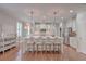 Bright, open-concept kitchen with marble island, seating, stainless appliances, and hardwood floors at 2036 Kings Gate Ln, Mount Pleasant, SC 29466