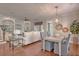 Inviting living space with hardwood floors, a built-in bookshelf, and a dining area with elegant light fixture at 2036 Kings Gate Ln, Mount Pleasant, SC 29466