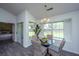 Bright dining area with a glass table, four chairs, and backyard view at 207 Apache Dr, Summerville, SC 29483