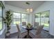 Bright dining area featuring a glass table, seating for four, and sunny backyard view at 207 Apache Dr, Summerville, SC 29483