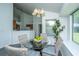 Bright dining area featuring a glass table, seating for four, and view to kitchen at 207 Apache Dr, Summerville, SC 29483
