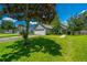 Beautiful single-story home with manicured lawn, mature trees, and attached two-car garage at 207 Apache Dr, Summerville, SC 29483