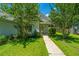 Inviting home entrance with flag, bushes, and sidewalk leading up to the front door at 207 Apache Dr, Summerville, SC 29483