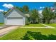 Well-maintained single-story home with lush lawn, attached garage and sidewalk leading to front door at 207 Apache Dr, Summerville, SC 29483