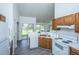 Traditional kitchen with wood cabinets, white appliances, and view of backyard at 207 Apache Dr, Summerville, SC 29483