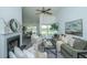 Bright living room with vaulted ceiling, fireplace, ceiling fan, and view into dining area at 207 Apache Dr, Summerville, SC 29483