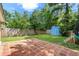 Landscaped backyard featuring a shed, wooden fence, brick patio, and lush green lawn at 207 Terry Ave, Summerville, SC 29485