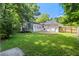 Expansive backyard with a brick patio, trampoline, and mature trees offering shade at 207 Terry Ave, Summerville, SC 29485
