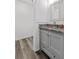 Bathroom with a granite countertop, grey vanity, and plank flooring at 207 Terry Ave, Summerville, SC 29485