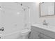 Bathroom with a tub, shower, toilet, grey vanity, and framed mirror at 207 Terry Ave, Summerville, SC 29485