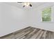 Bright bedroom with a ceiling fan, plank flooring, and a view to the outside at 207 Terry Ave, Summerville, SC 29485