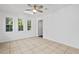 Neutral bedroom features three bright windows, tile floor, ceiling fan, and direct access to another room at 207 Terry Ave, Summerville, SC 29485