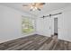 Bright bedroom with a ceiling fan, sliding closet door, and plank flooring at 207 Terry Ave, Summerville, SC 29485