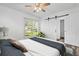 Bright bedroom with a ceiling fan, sliding closet door, and a view to the outside at 207 Terry Ave, Summerville, SC 29485