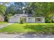 Charming single-story home with solar panels, lush lawn, and mature trees at 207 Terry Ave, Summerville, SC 29485