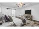 This primary bedroom features a sliding barn door leading to the bath, modern decor, and great natural light at 207 Terry Ave, Summerville, SC 29485