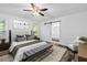 This primary bedroom features a sliding barn door leading to the bath, modern decor, and great natural light at 207 Terry Ave, Summerville, SC 29485