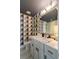 Stylish bathroom featuring modern geometric wallpaper, gray cabinets, and quartz countertop at 211 Line St, Charleston, SC 29403