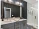 Modern bathroom with double sink vanity, patterned wallpaper, and a walk-in shower at 211 Line St, Charleston, SC 29403
