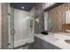 Modern bathroom featuring a glass-enclosed shower, stylish vanity, and birch tree wallpaper at 211 Line St, Charleston, SC 29403
