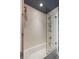 Modern tub shower combination featuring white subway tile, glass door, and chrome fixtures at 211 Line St, Charleston, SC 29403