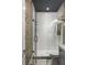 Bathroom featuring a glass-enclosed shower, birch-themed wallpaper, and modern fixtures at 211 Line St, Charleston, SC 29403