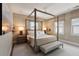 Spacious bedroom with four-poster bed, neutral palette, and natural light from two windows at 211 Line St, Charleston, SC 29403