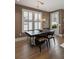 Dining room features a modern chandelier, large window with plantation shutters, and a view to the outside at 211 Line St, Charleston, SC 29403
