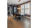 Dining room boasts a modern chandelier, large window with plantation shutters, and hardwood floors at 211 Line St, Charleston, SC 29403
