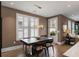 Dining room features a modern chandelier, large window with plantation shutters, and a view to the outside at 211 Line St, Charleston, SC 29403