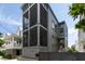 Elegant gray home features a screened porch, yellow front door, and manicured landscaping at 211 Line St, Charleston, SC 29403