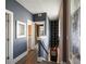 View of second story hallway with wood floors and access to bathroom and stairs at 211 Line St, Charleston, SC 29403
