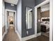 Hallway leading to a bedroom with a four-poster bed, neutral colors, and decorative wallpaper at 211 Line St, Charleston, SC 29403