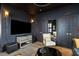 Stylish living room with dark walls, a comfortable chair, large television, and elegant decor at 211 Line St, Charleston, SC 29403