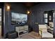 Chic living room with a modern TV, dark walls, and decorative lighting fixtures at 211 Line St, Charleston, SC 29403