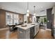 Open-concept kitchen, dining, and living area with hardwood floors and natural light at 211 Line St, Charleston, SC 29403