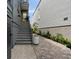 Side entrance with stairs leading to a yellow door and a well-maintained walkway at 211 Line St, Charleston, SC 29403