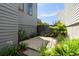 Beautifully landscaped side yard with a privacy gate and lush greenery at 211 Line St, Charleston, SC 29403