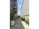 Landscaped side yard with a charming brick walkway and mature plantings at 211 Line St, Charleston, SC 29403
