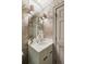 Elegant powder room with designer wallpaper, marble countertop, and vintage-style fixtures at 22 Lamboll St # C, Charleston, SC 29401