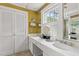 Bright bathroom features double sinks with marble countertops and classic white cabinetry at 22 Lamboll St # C, Charleston, SC 29401