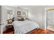 Bright bedroom with hardwood floors, shuttered windows, and comfortable bedding at 22 Lamboll St # C, Charleston, SC 29401