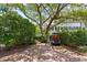 Brick driveway with a golf cart parked under a large tree, offering ample parking space at 22 Lamboll St # C, Charleston, SC 29401
