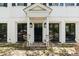 Charming home entryway with a black front door, brick accents, and decorative lighting fixtures at 22 Lamboll St # C, Charleston, SC 29401