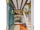 Inviting foyer with brick fireplace, hardwood floors, and a staircase leading to the upper level at 22 Lamboll St # C, Charleston, SC 29401